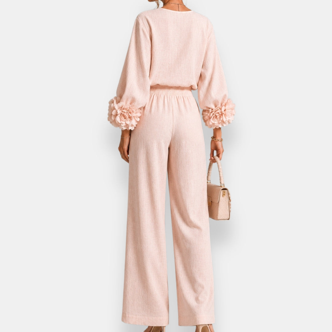 Side profile of a model wearing white wide-leg trousers, demonstrating their elegant movement and relaxed fit.