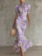 Back view of the romantic pink floral maxi dress, emphasizing its elegant drape and overall design.