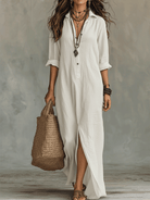 Woman walking outdoors in a black long sleeve maxi dress, demonstrating its graceful movement.