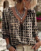 Green Xylia blouse displayed on a mannequin, allowing for a clear view of its cut and design.