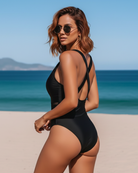 Side profile of the navy one-piece swimsuit, highlighting the flattering cut and smooth fabric.