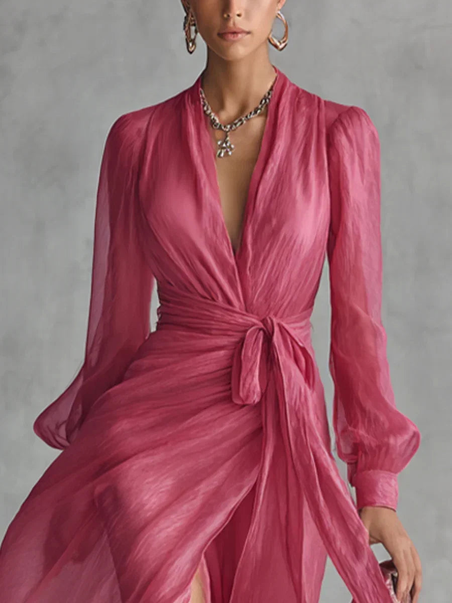 A woman wearing the flowing pearlescent maxi dress, walking outdoors in a serene garden party setting.