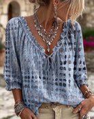 Black Xylia blouse in a studio shot, emphasizing its versatility for various casual occasions.