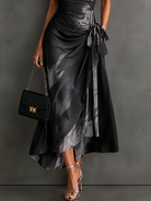 Grey artistic print maxi dress in an indoor studio shot, highlighting the garment's quality and design.