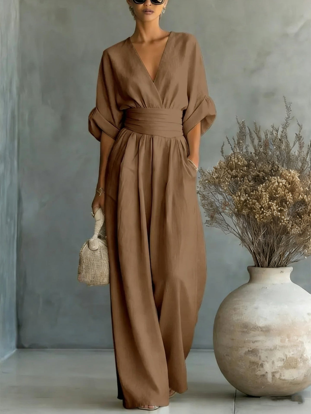 Overhead flat lay showing multiple color variations of the chic V-neck jumpsuit available.
