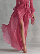 Side profile of the long-sleeved chiffon maxi dress, emphasizing the soft slit and delicate pearlescent fabric for evening wear.