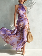 Elysia animal print maxi dress in blue, styled for an evening event, with accessories and elegant footwear.