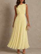 Close-up detail of the wide ruched waistband on the green chiffon dress, showing its comfortable stretch.