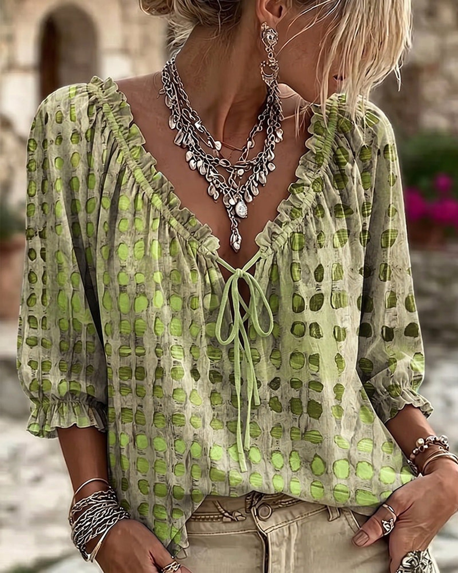 Orange Xylia blouse with a close-up of the hemline, ensuring quality and finishing details.