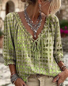 Orange Xylia blouse with a close-up of the hemline, ensuring quality and finishing details.