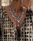 Pink Xylia blouse with the ruffled neckline gently falling, enhancing its feminine appeal.