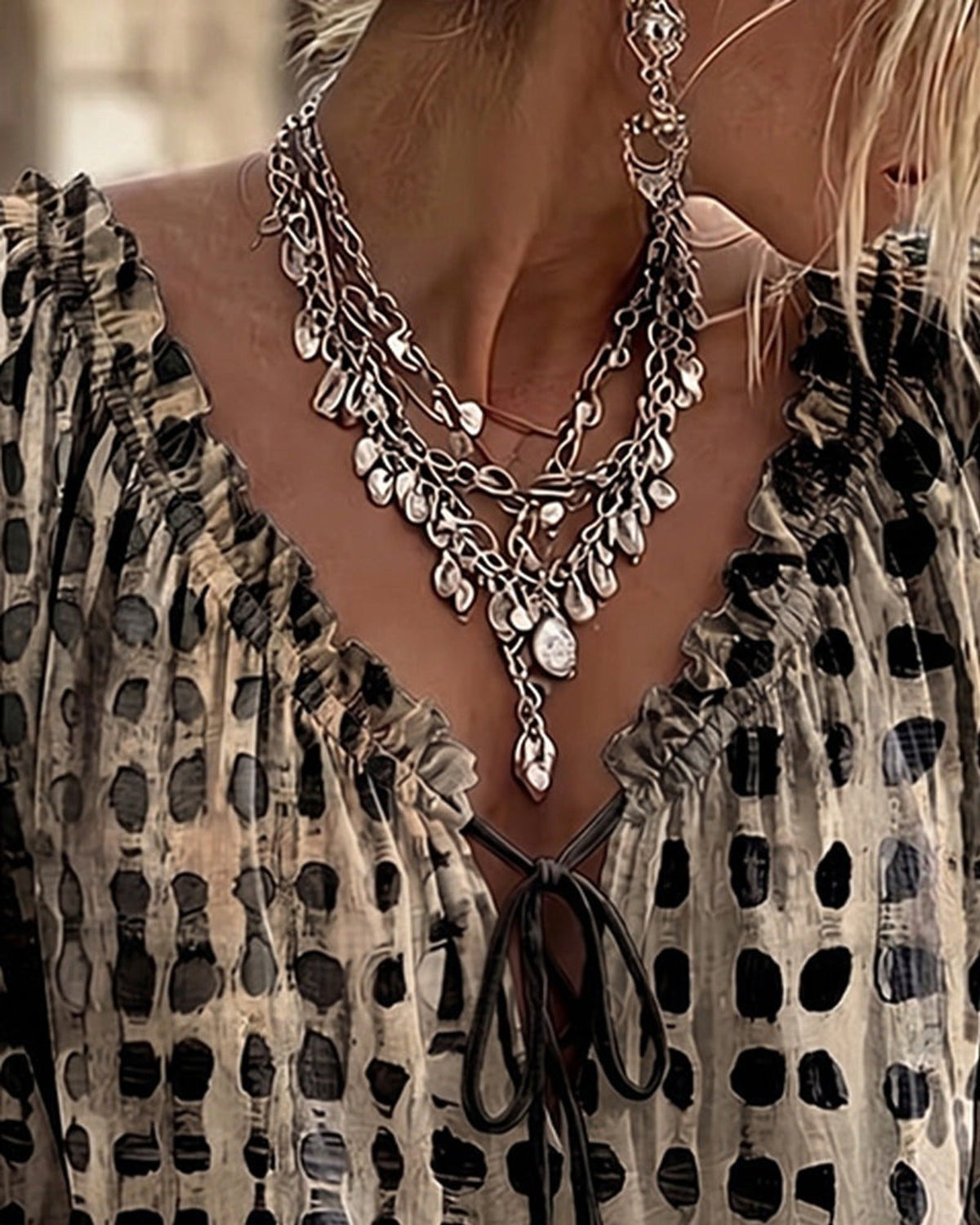 Pink Xylia blouse with the ruffled neckline gently falling, enhancing its feminine appeal.