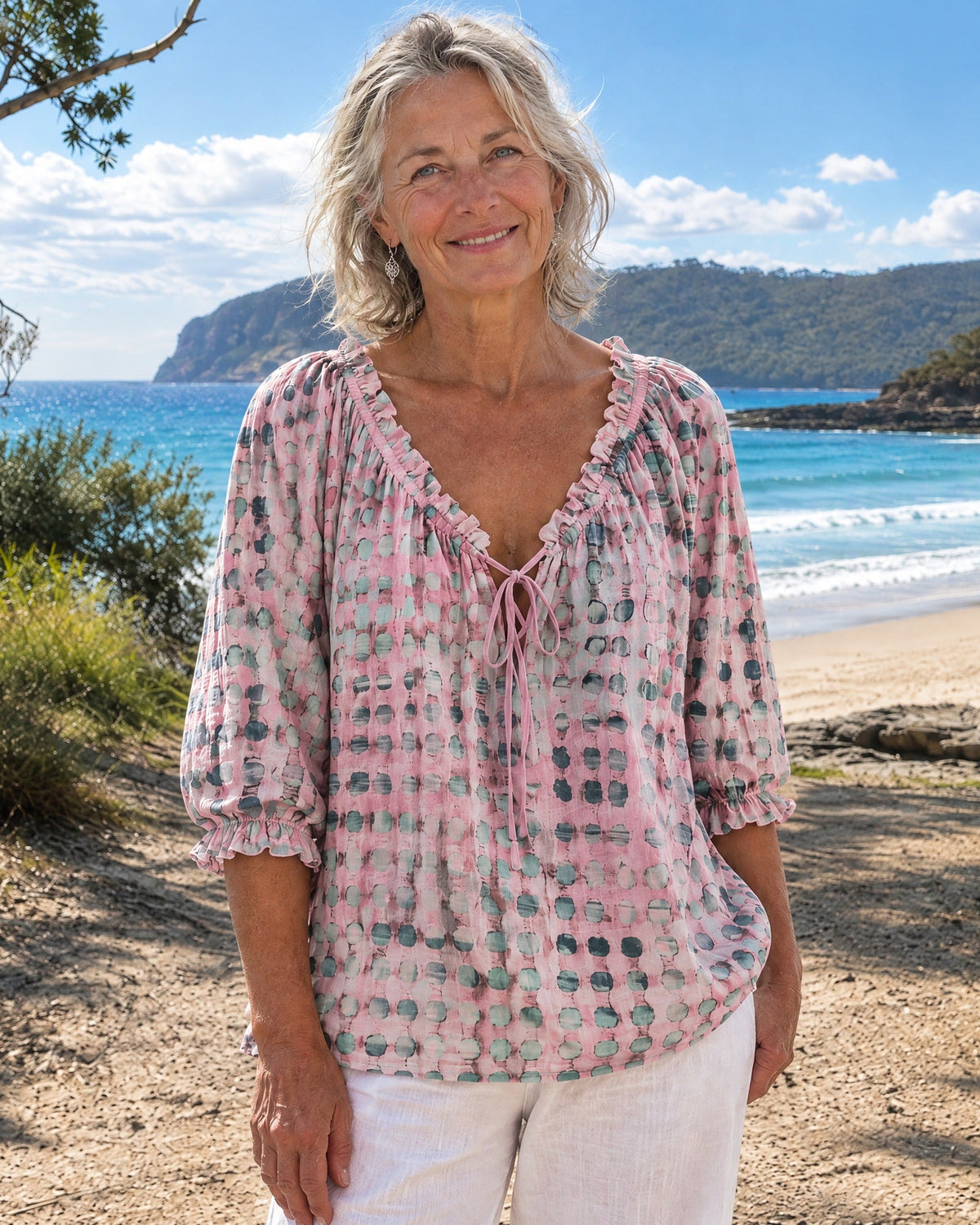 Side profile of the pink Xylia blouse, highlighting the flowing silhouette and three-quarter sleeves.