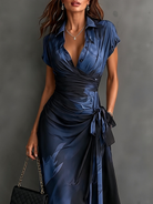 Full length shot of a grey artistic print maxi dress, styled with accessories for an evening event.