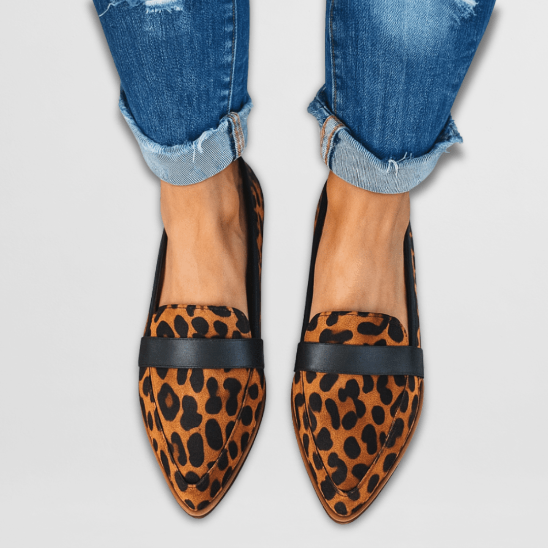 Detail shot of the back of a grey suede loafer, focusing on the durable, shock-absorbing outsole and heel construction.