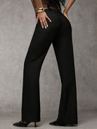 Model wearing elegant beige high-waisted trousers, styled casually for a comfortable, chic everyday look.