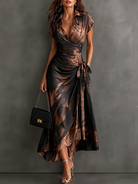 Lower hem detail of a blue abstract print maxi dress, illustrating the ruffled high-low design.