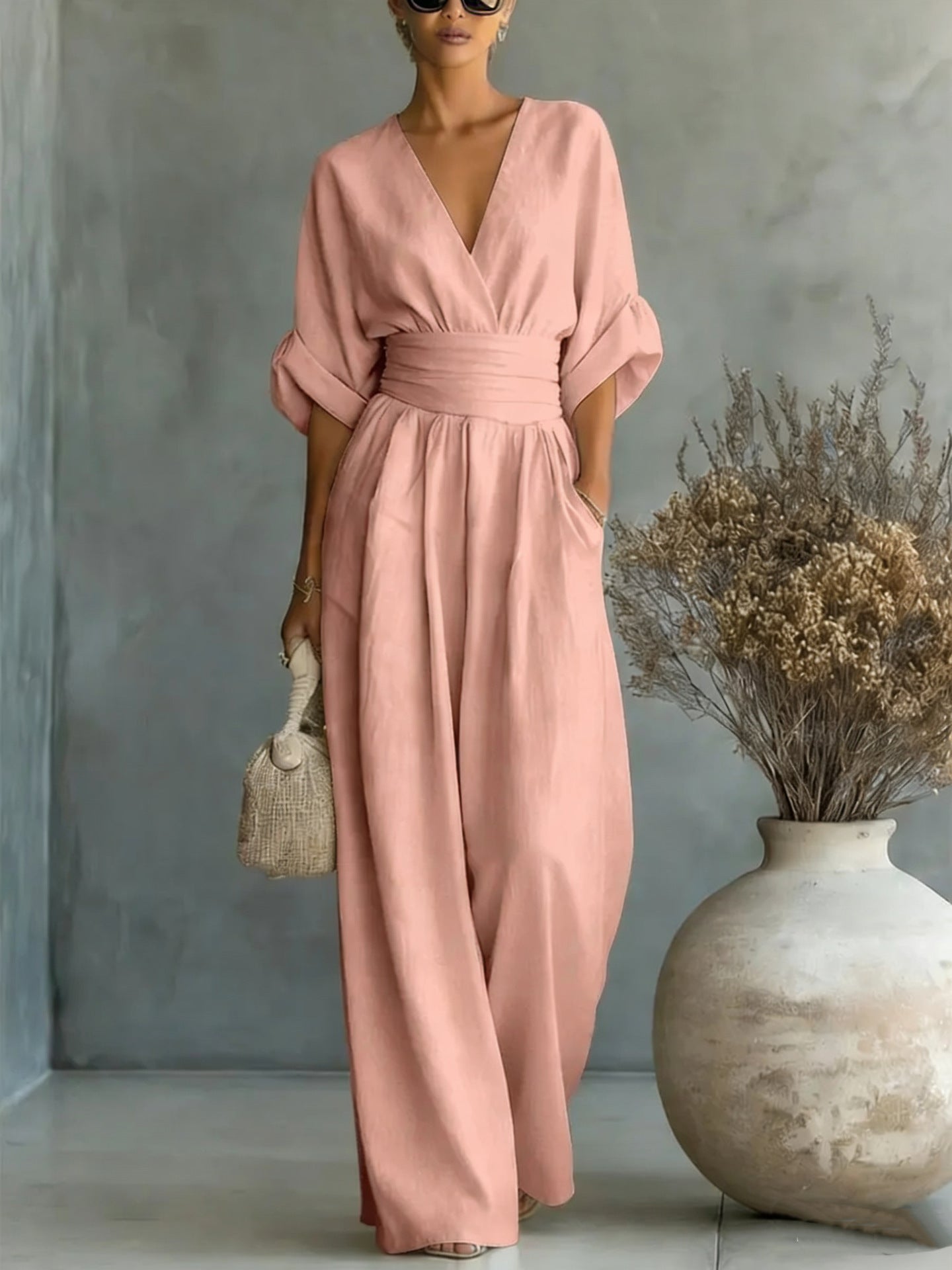 Another color option, a pink jumpsuit, worn by a model, perfect for festive occasions.