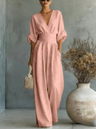 Another color option, a pink jumpsuit, worn by a model, perfect for festive occasions.