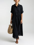 Folded khaki cotton shirt dress, displaying the material's texture and casual appeal before wear.