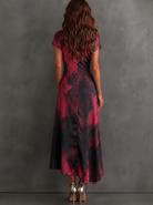 Close-up of the fabric on a purple abstract maxi dress, showing the matte milk silk finish and print texture.