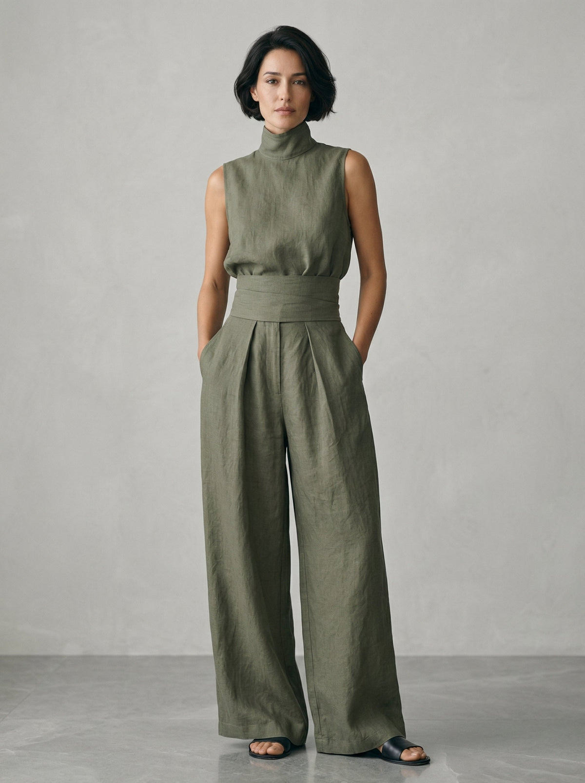 Stack of neatly folded wide-leg trousers in various appealing colors: beige, olive, light blue, and blush pink.