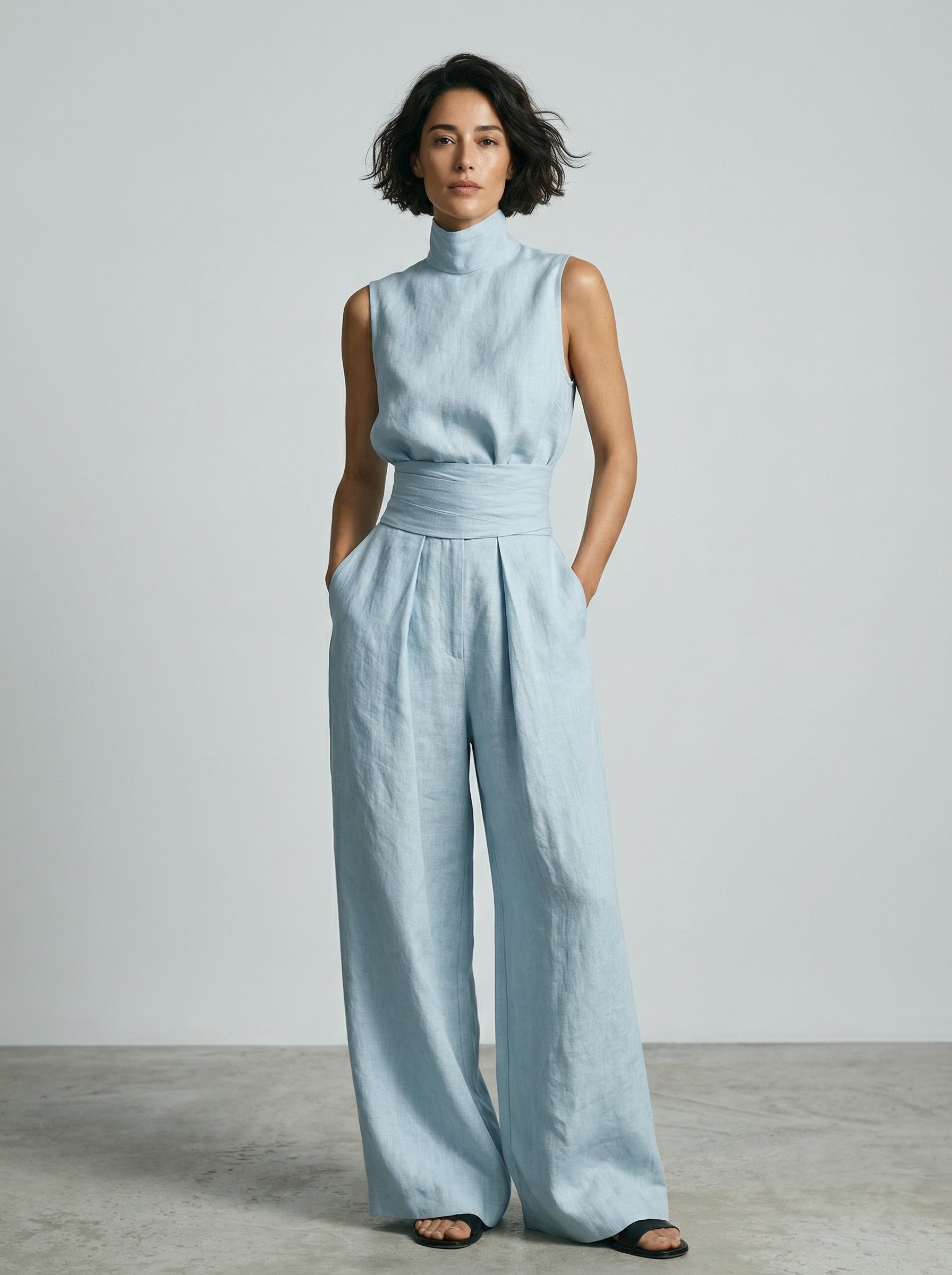 Overhead view of the wide-leg cotton trousers laid flat, showing the full, generous cut and material.