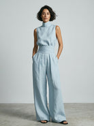 Overhead view of the wide-leg cotton trousers laid flat, showing the full, generous cut and material.