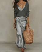 Front view of a gray Romy ribbed knit sweater, styled casually with jeans for an everyday look.