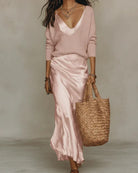 Front view of a white Romy ribbed knit pullover sweater, showcasing its soft texture and elegant drape.