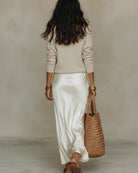 Back view of a black Romy ribbed knit pullover sweater, emphasizing its smooth, seamless design.