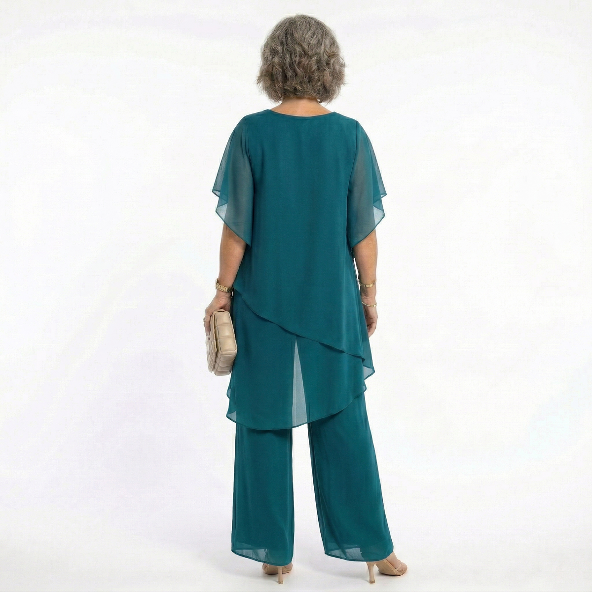 Detail shot of the neckline and shoulder area of the navy tiered blouse, emphasizing its quality and finish.
