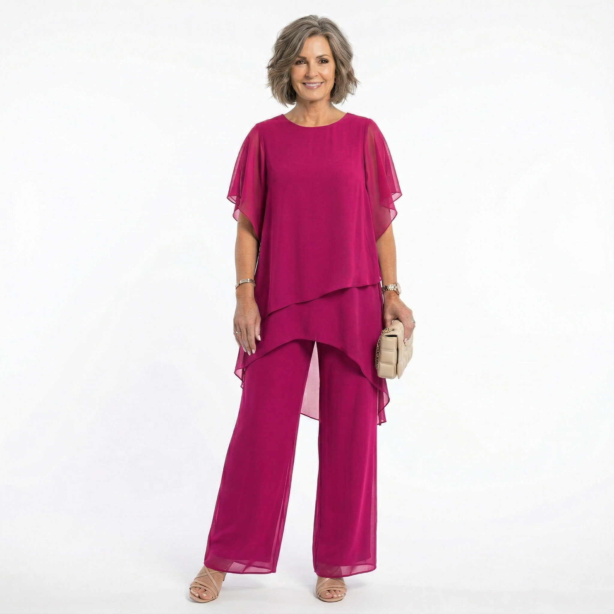 Model gracefully turning in a magenta blouse, showcasing the beautiful movement of its tiered design.