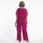 A stack of folded Tamsin blouses in various available colors, highlighting the range of choices.