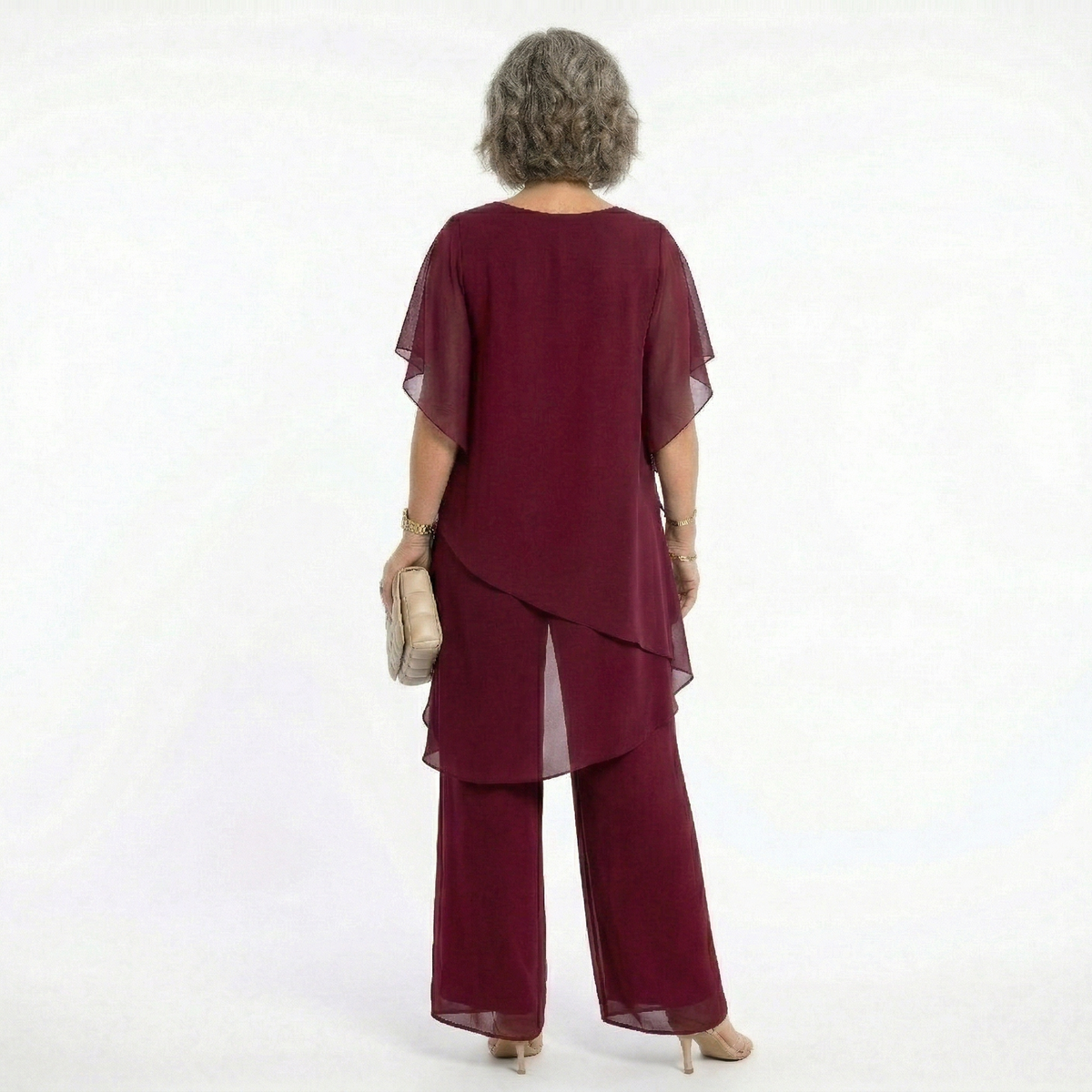 Back view of the blush pink tiered blouse, revealing its gentle lines and sophisticated, modest coverage.