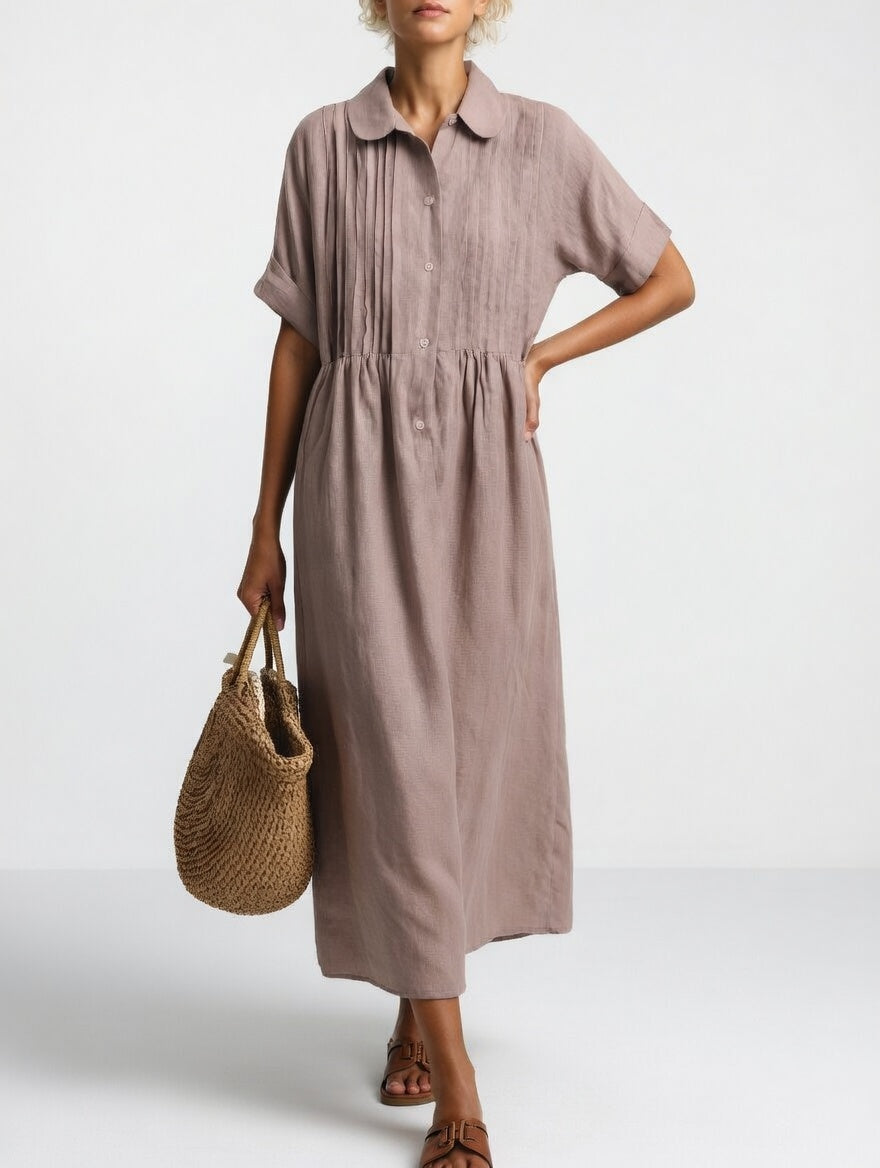 Model wearing the blue cotton dress, captured in a dynamic pose to show the freedom of movement.