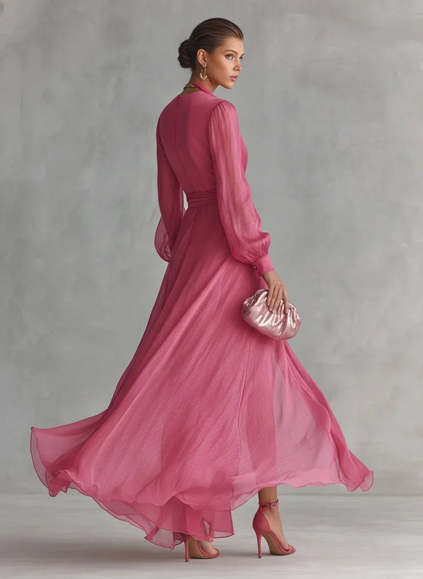 Front view of a pearlescent rose pink maxi dress with a deep V-neckline and long sleeves, perfect for formal events.