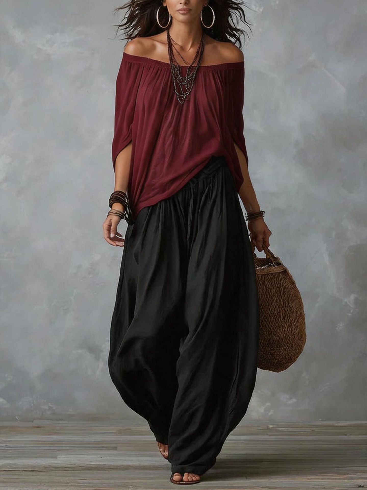 Lifestyle shot of the black casual trousers in a relaxed outdoor setting, paired with accessories.