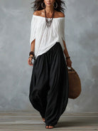 Front view of Adora black relaxed fit trousers on a model, styled with a simple top.