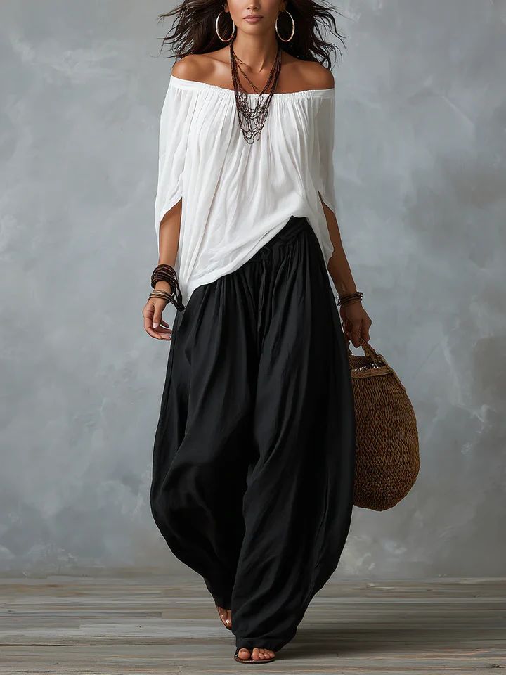 Front view of Adora black relaxed fit trousers on a model, styled with a simple top.