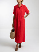 Rear view of the pink cotton dress, showing the subtle waist structure and overall elegant drape.