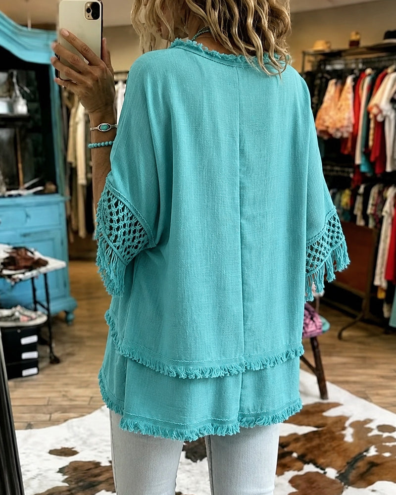Side profile of the relaxed fit crochet blouse, highlighting its flowing shape and comfortable design.