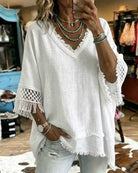 A woman wearing the aqua green easygoing crochet blouse, styled casually with jeans for a relaxed look.