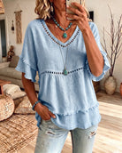 Lifestyle shot of the Elowyn blouse styled casually with light-colored trousers, perfect for a relaxed day out.