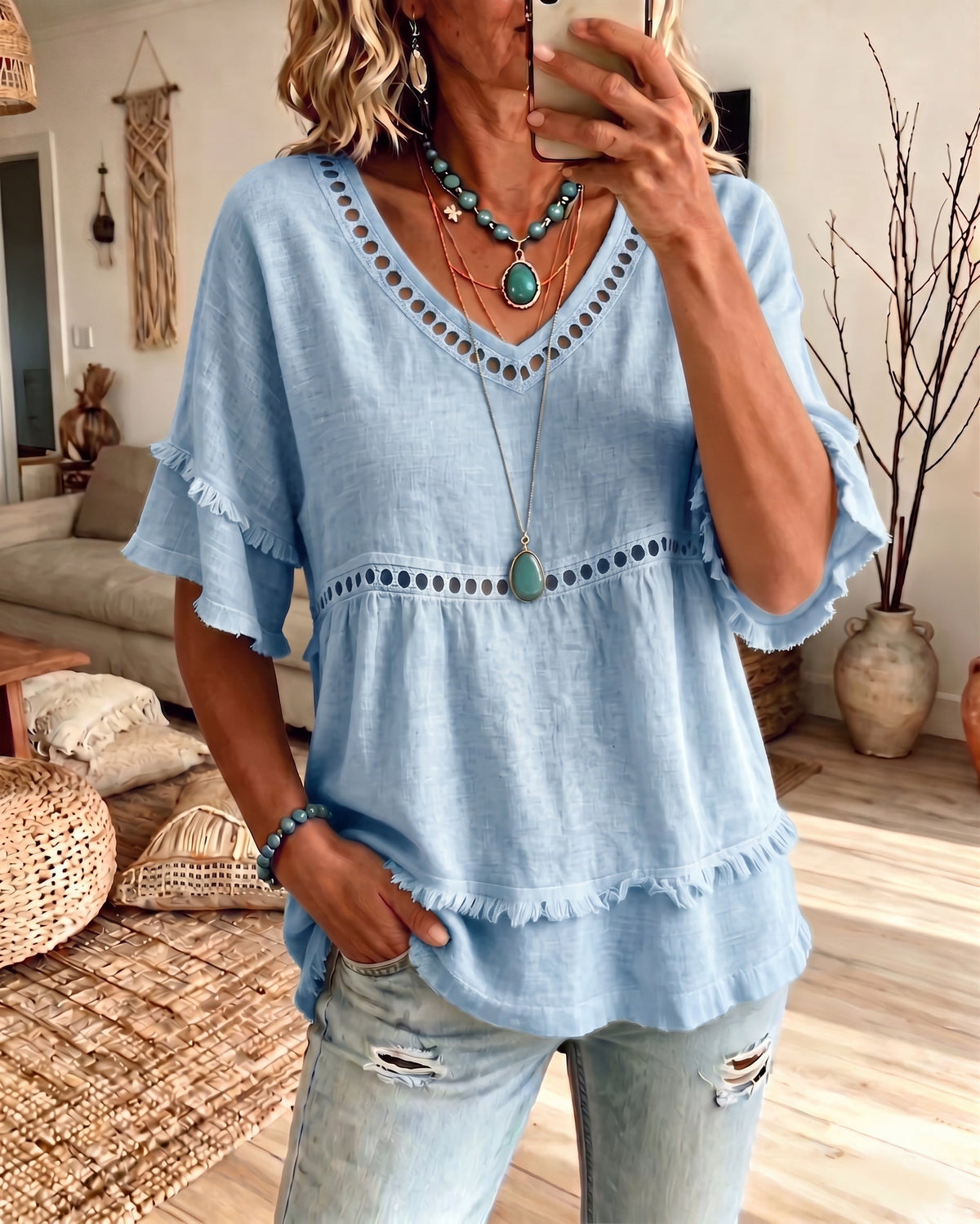 Lifestyle shot of the Elowyn blouse styled casually with light-colored trousers, perfect for a relaxed day out.