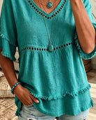 Close-up on the delicate frill trim detail along the neckline of the blouse, highlighting craftsmanship.