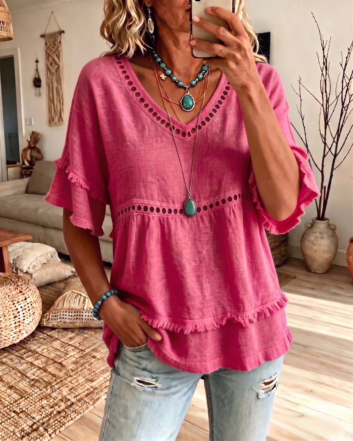 Detailed image of the V-neck and soft sleeve shape of the blouse, emphasizing its feminine and laid-back design.