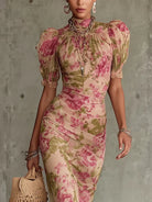 Detailed view of the high ruffled neckline and delicate puff sleeves on the floral maxi dress.