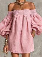 Side view of the pink off-shoulder mini dress, highlighting the flowing A-line shape and movement.