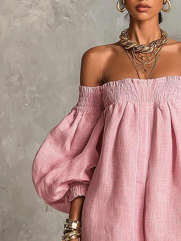 A model wearing the pink off-shoulder mini dress in a relaxed setting, showcasing its romantic style.
